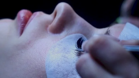 Close up. Lashes extentions procedure on white woman. Middle of procedure Stock Footage 150599580
