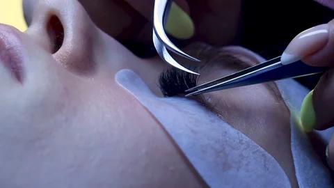 Close up. Lashes extentions procedure on white woman. Finish of procedure Stock Footage 150599649