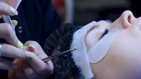 Close up. Lashes extentions procedure on white woman. Middle of procedure Stock Footage 150599708