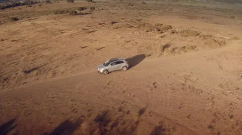 Close up lateral aerial view of a 4 by 4 car through the desert. Spain. Stock Footage 47330727