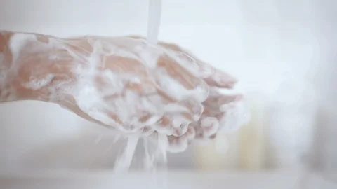 Close up lathering hands with soap hand sanitizer gel then water washing in t Stock Footage 127615405