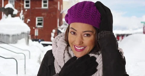 Close up of Latina female standing outside in the snow, smiling and laughing Stock Footage
