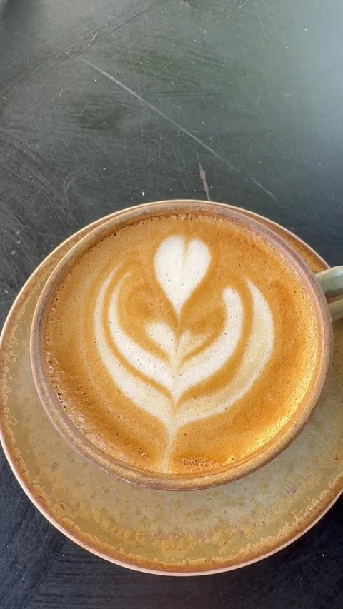 Close Up Of Latte Art Coffee Cup On Outdoor Cafe Table Stock Footage 335903481