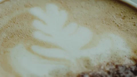 Close-Up of Latte Art Coffee With Leaf Design in Frothy Milk Stock Footage 313340349