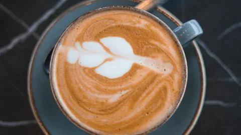 Close-up of a latte with a beautiful pattern, showcasing creamy coffee art Stock Photos