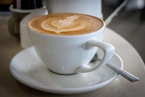 A close up of a latte with decorative pattern, with a shallow depth of field Stock Photos