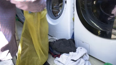 Close up of laundry of homeless being prepared to be loaded on the washing ma 스톡 동영상 117433033