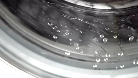 Close up laundry machine housework clean domestic household washing equipment Stock Footage 336589743