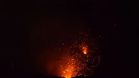 CLOSE UP: Lava exploding from the depths of Mount Yasur lighting up the crater. Stock Footage 103233472