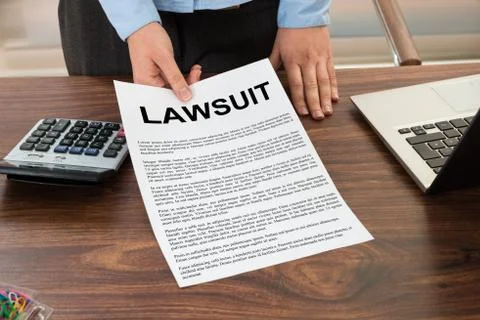 Close-up Lawyer Showing The Document With The Text Lawsuit Stock Photos