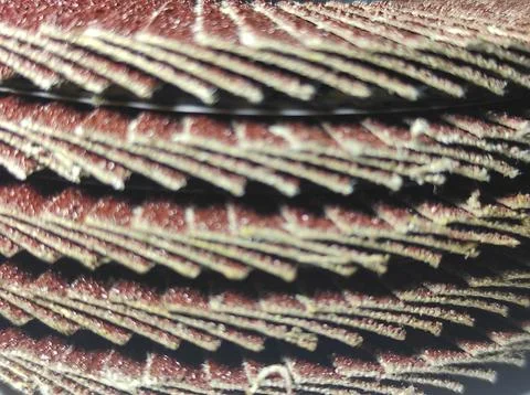Close-up of layered abrasive flaps arranged in a radial pattern. Stock Photos