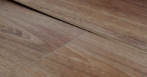 Close-up of laying laminate on prepared substrate, wooden floor, lock joining Stock Footage 130368181