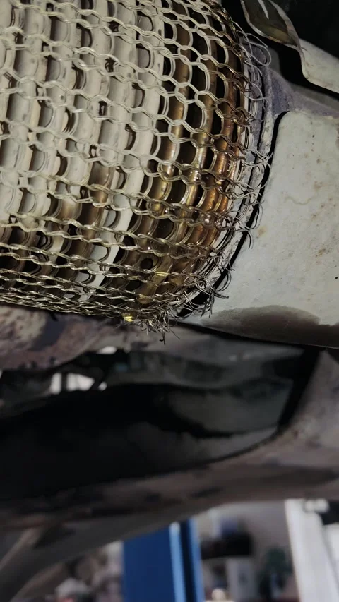 Close up of leaking liquid from car exhaust pipe flex beller Stock Footage 333408686
