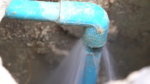 Close up leaking water from blue pipe from underground Stock Footage 88906925