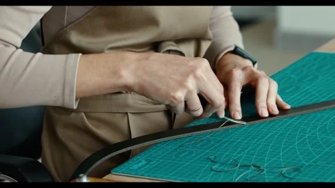 Close-up. Leather handbag craftsman at work in a workshop. Woman's hands holding Video stock 298957094