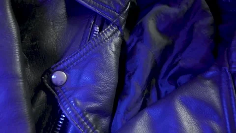 Close-Up of Leather Jacket in Changing Blue Light Stock Footage 301346935