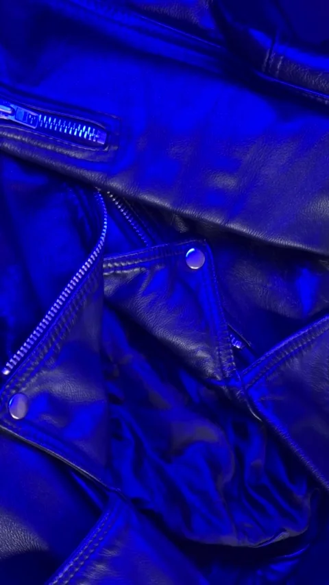 Close-Up of Leather Jacket in Changing Blue Light Stock Footage 301346977
