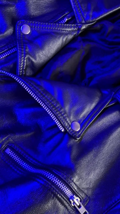 Close-Up of Leather Jacket in Changing Blue Light Stock Footage 301346985