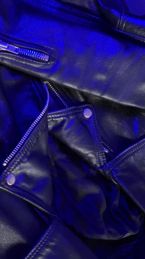 Close-Up of Leather Jacket in Changing Blue Light Stock Footage 301346993