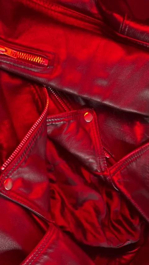 Close-up of a Leather Jacket in Shifting Red Light. Vertical footage Stock Footage 301188213