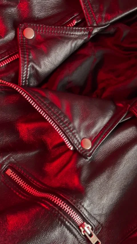 Close-up of a Leather Jacket in Shifting Red Light. Vertical footage Stock Footage 301188541