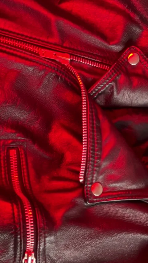 Close-up of a Leather Jacket in Shifting Red Light. Vertical footage Stock Footage 301188558