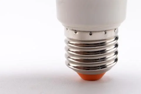 Close-up of LED Light Bulb Base with Silver Threads and Orange Tip on White.. Stock Photos