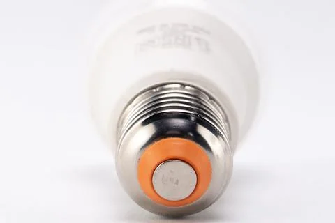 Close-up of LED Light Bulb Base with Silver and Orange Details on White Bac.. Stock Photos