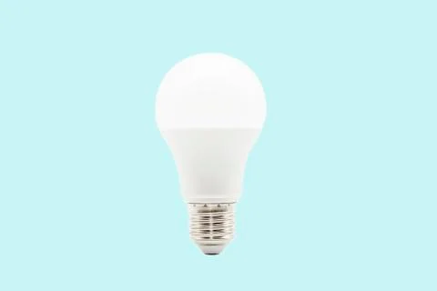 Close up LED white light bulb isolated on blue background. Stock Photos