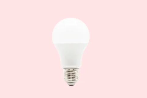 Close up LED white light bulb isolated on pastel pink background. Stock Photos