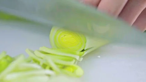 Close up of leek being cut Stock Footage 84280322
