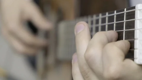 Close up of left hand playing guitar Stock Footage 114633432