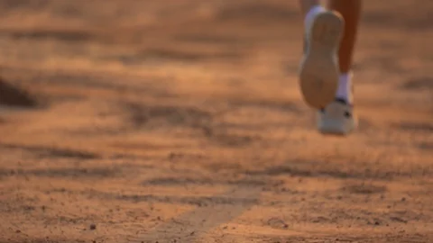 Close up leg of boy running on ground in rural on light of sunset background Stock-Footage 129638915