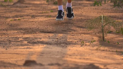 Close up leg of boy running on ground in rural on light of sunset background 스톡 동영상 129639047