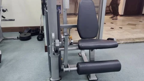 Close-up of leg extension machine in a modern fitness studio Stock Footage 304093293
