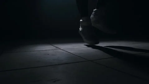 Close-up of a leg jumping rope in a dark room with back light  Stock-Footage 274428998