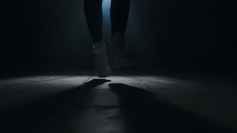 Close-up of a leg jumping rope in a dark room with back light  Stock-Footage 274429091