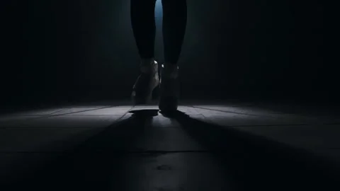 Close-up of a leg jumping rope in a dark room with back light  Stock-Footage 274429121