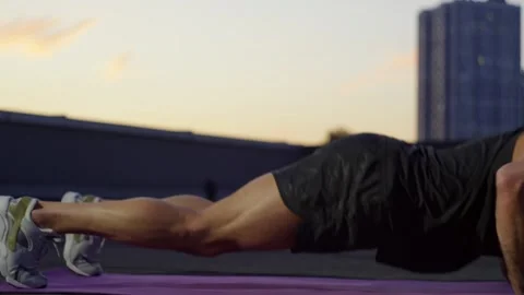 A close-up of the legs of an athlete doing an exercise pushing up from the floor Stock Footage 256138359