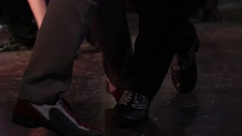 Close-up of legs dancing tango in slow motion on dark floor. Stock Footage 169494964