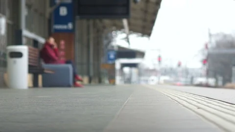 Close-up of the legs go along the platform of the railway station, a suitcase is Stock Footage 105541564