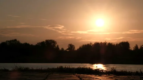 A close-up of the legs of a man riding a gyroscope or a segway at dawn along the Stock Footage 94337856