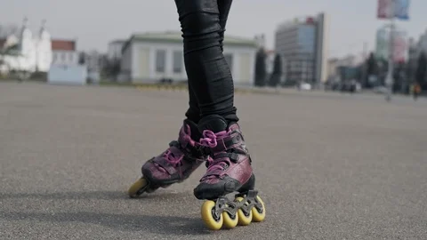 Close up of legs rides on roller skates and whirl. Girl driving roller skates. Video stock 106769926