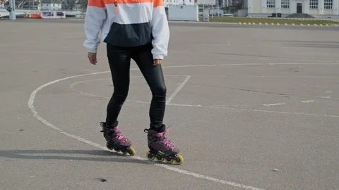 Close up of legs rides on roller skates and whirl. Girl driving roller skates. Video stock 106804274