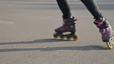 Close up of legs rides on roller skates and whirl. Girl driving roller skates. Vídeo Stock 106805531