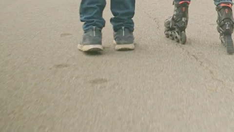 Close-up. legs of a roller skater are rollerblading on street asphalt pavement. Stock Footage 280209387