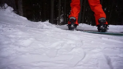 Close up legs snowboarder in move Stock Footage 122816531
