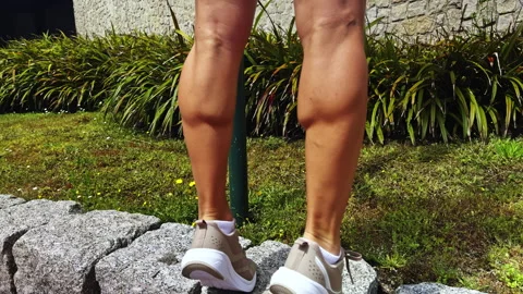 Close-up of Legs on Stone Edge Stock Footage 280255528