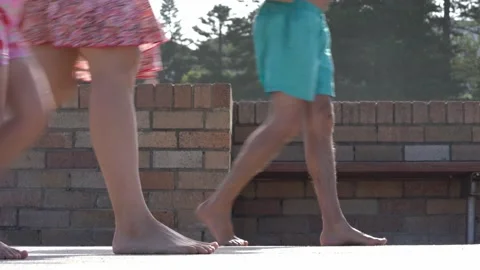Close up legs walking on beach side - barefoot - sport shoes - dogs Video stock 197447080
