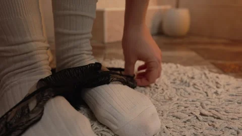 Close-up legs in warm white socks in the toilet hands puts on panties Stock Footage 270243278